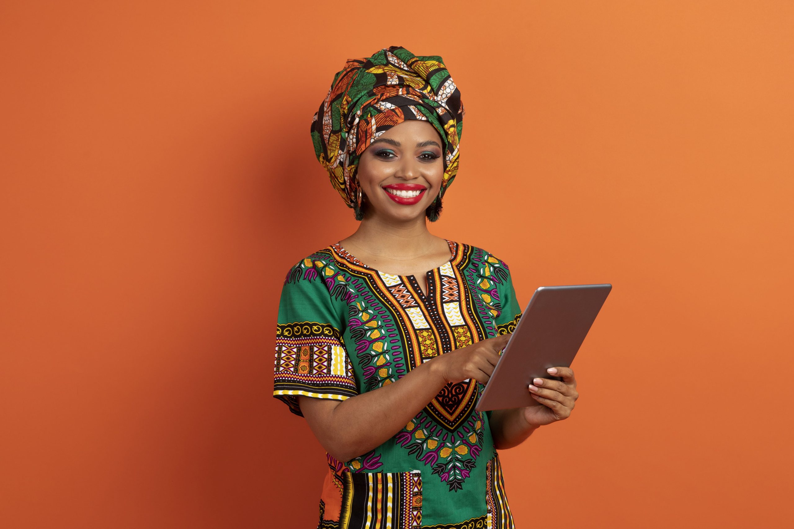 smiling-woman-wearing-colorful-headwrap-holding-ta-2026-03-24-03-03-57-utc